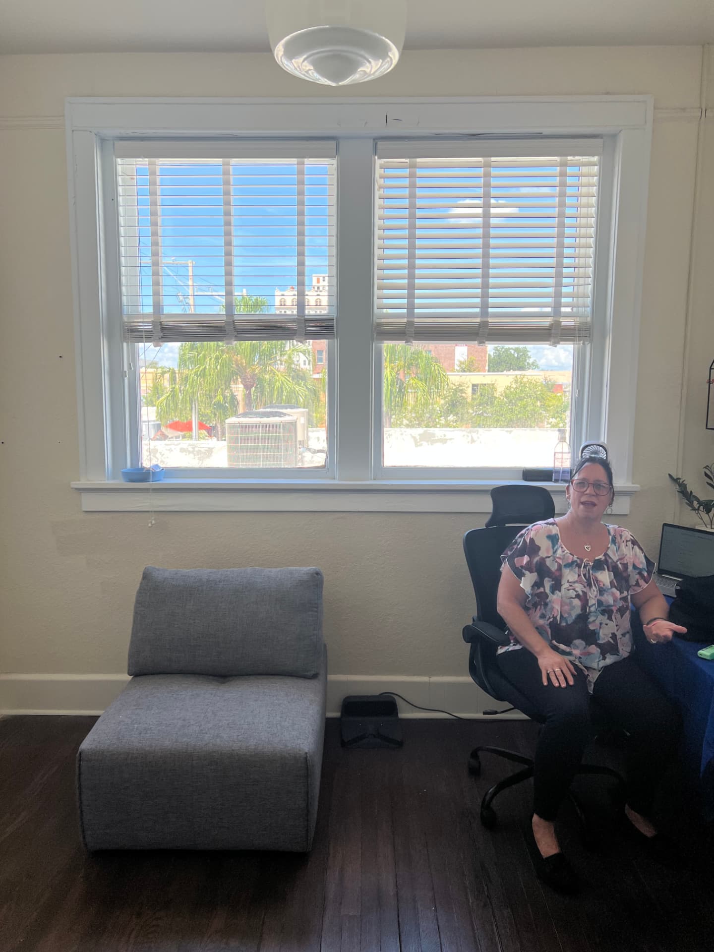 Bright member workroom with downtown Lake Wales views, lounge seating, and an ergonomic chair