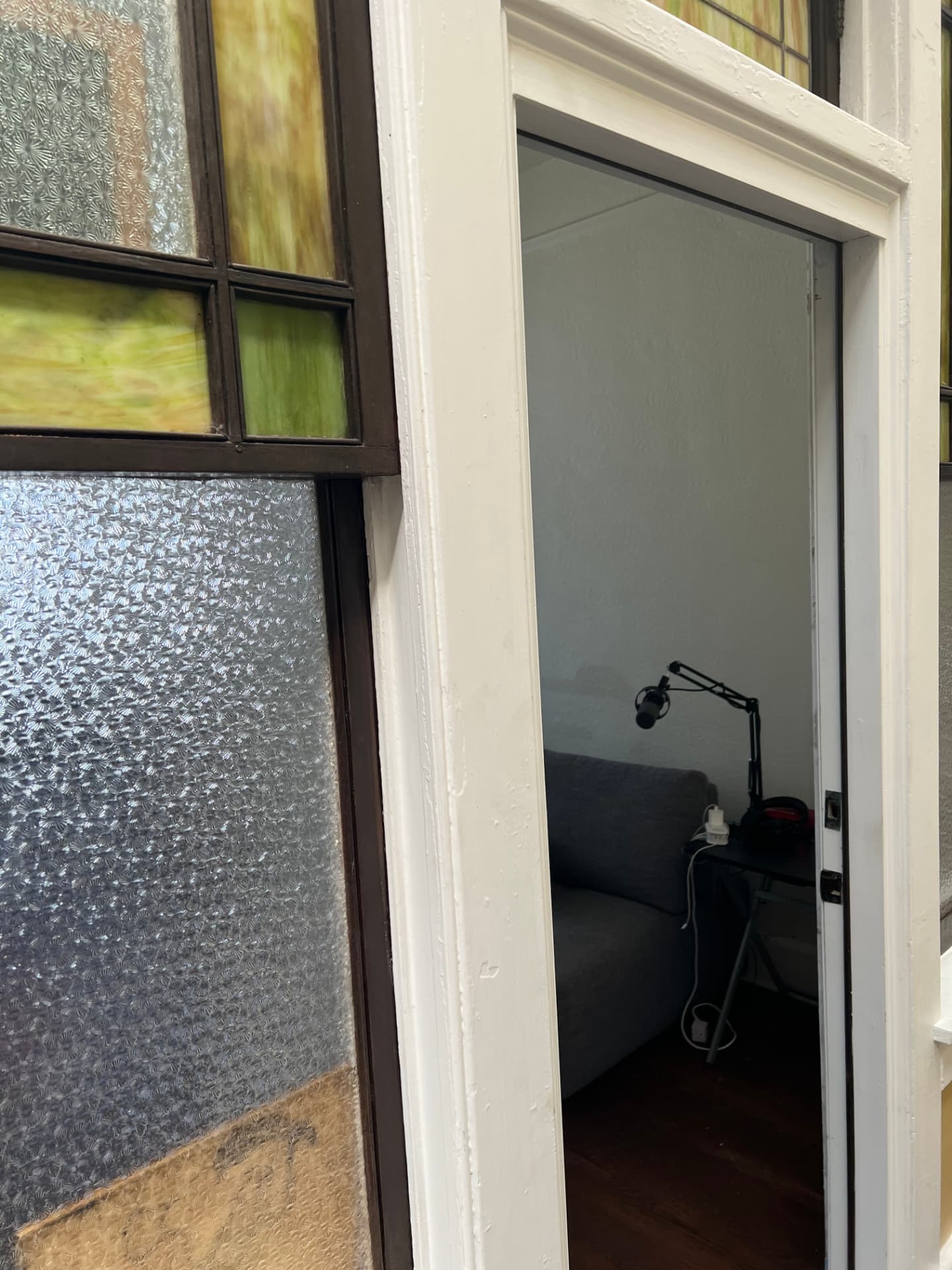Original green stained glass and textured glass beside the studio door