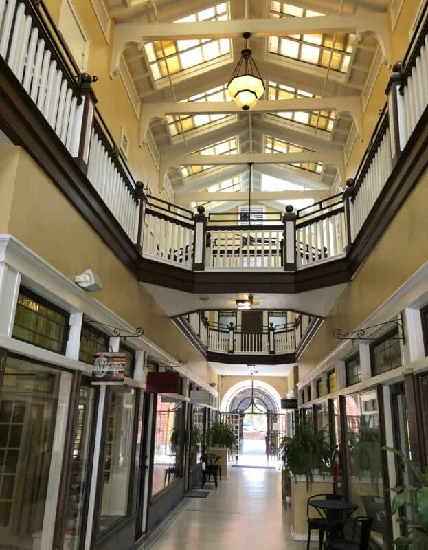 Two-story arcade corridor with skylights, wood balconies, and storefronts
