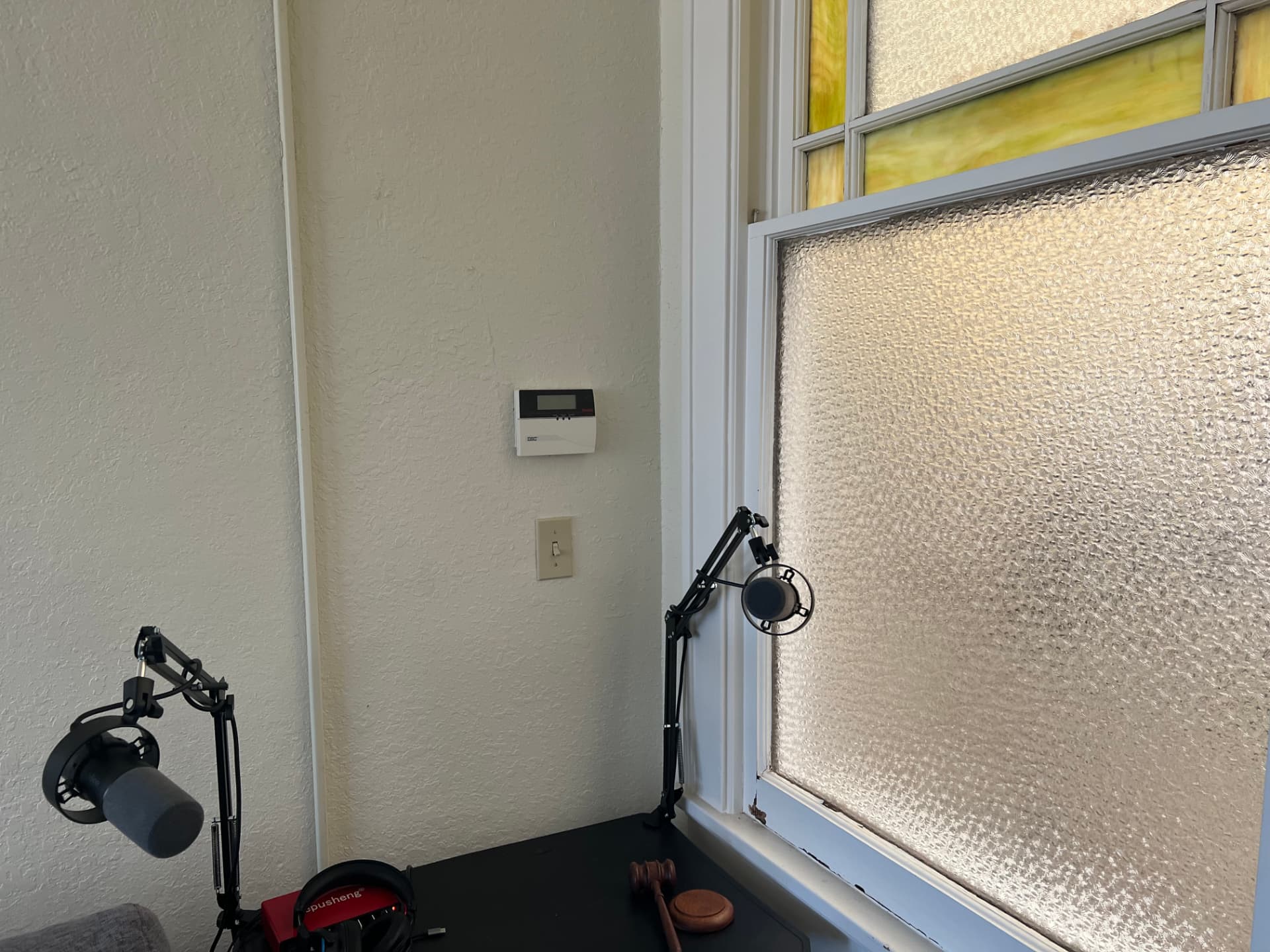 Two broadcast microphones on boom arms in the WorkLW.com podcast studio